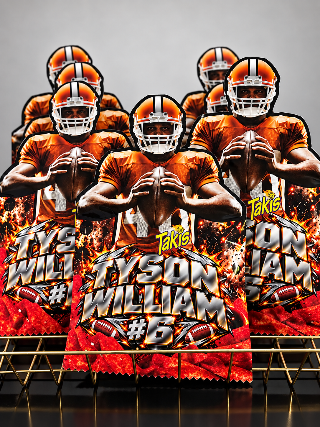 A set of custom football-themed party decorations, including printed signs and table runners, featuring a graphic of quarterback Tyson Williams in an orange jersey and helmet with flames and the name 'Tyson Williams #6'.