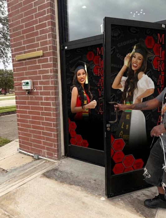 Digital display on a building exterior showing two women, one with a graduation cap.
