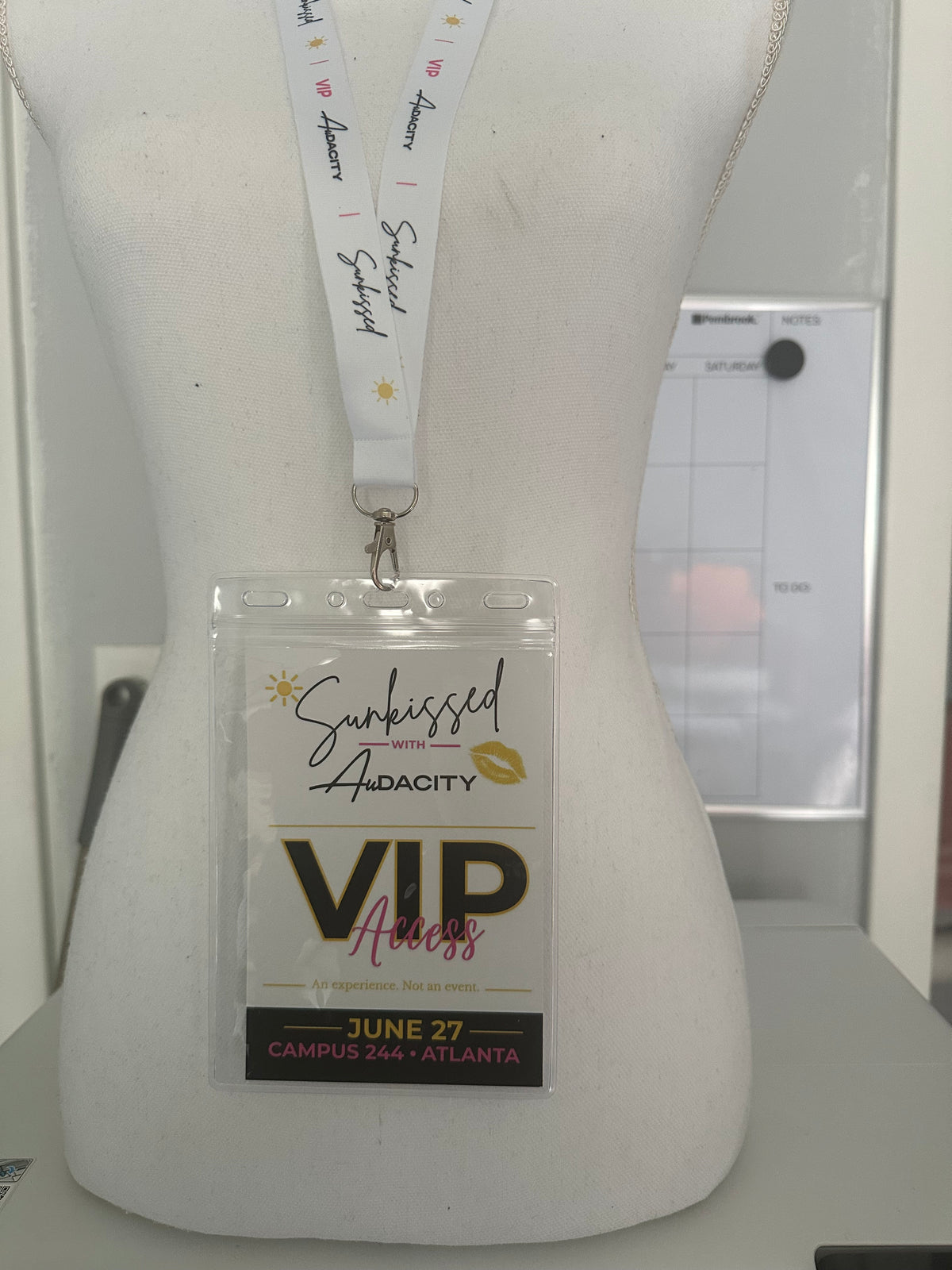 White dress with a 'VIP' badge on a white background